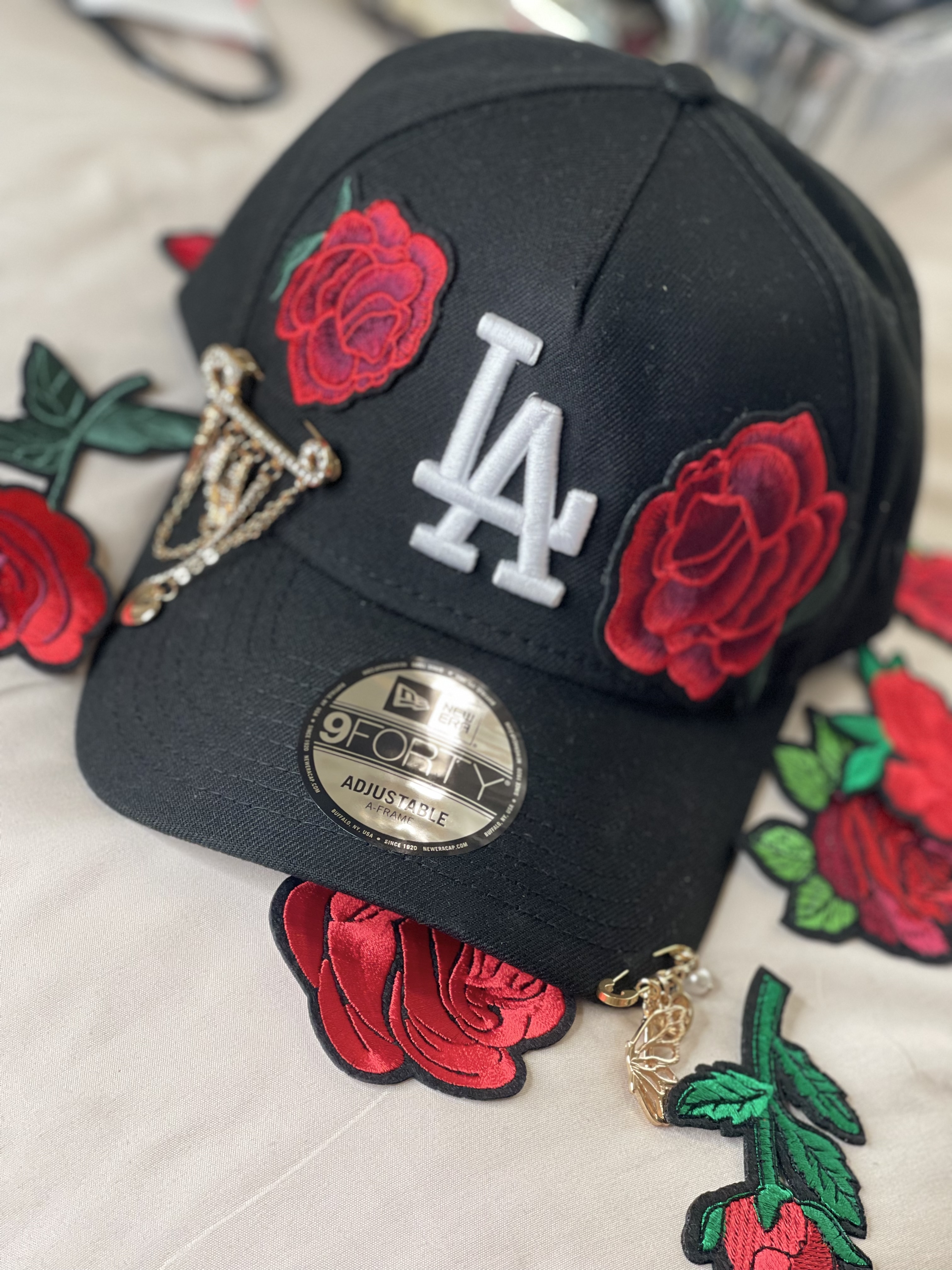 Black LA snapback with red rose patches and gold charms