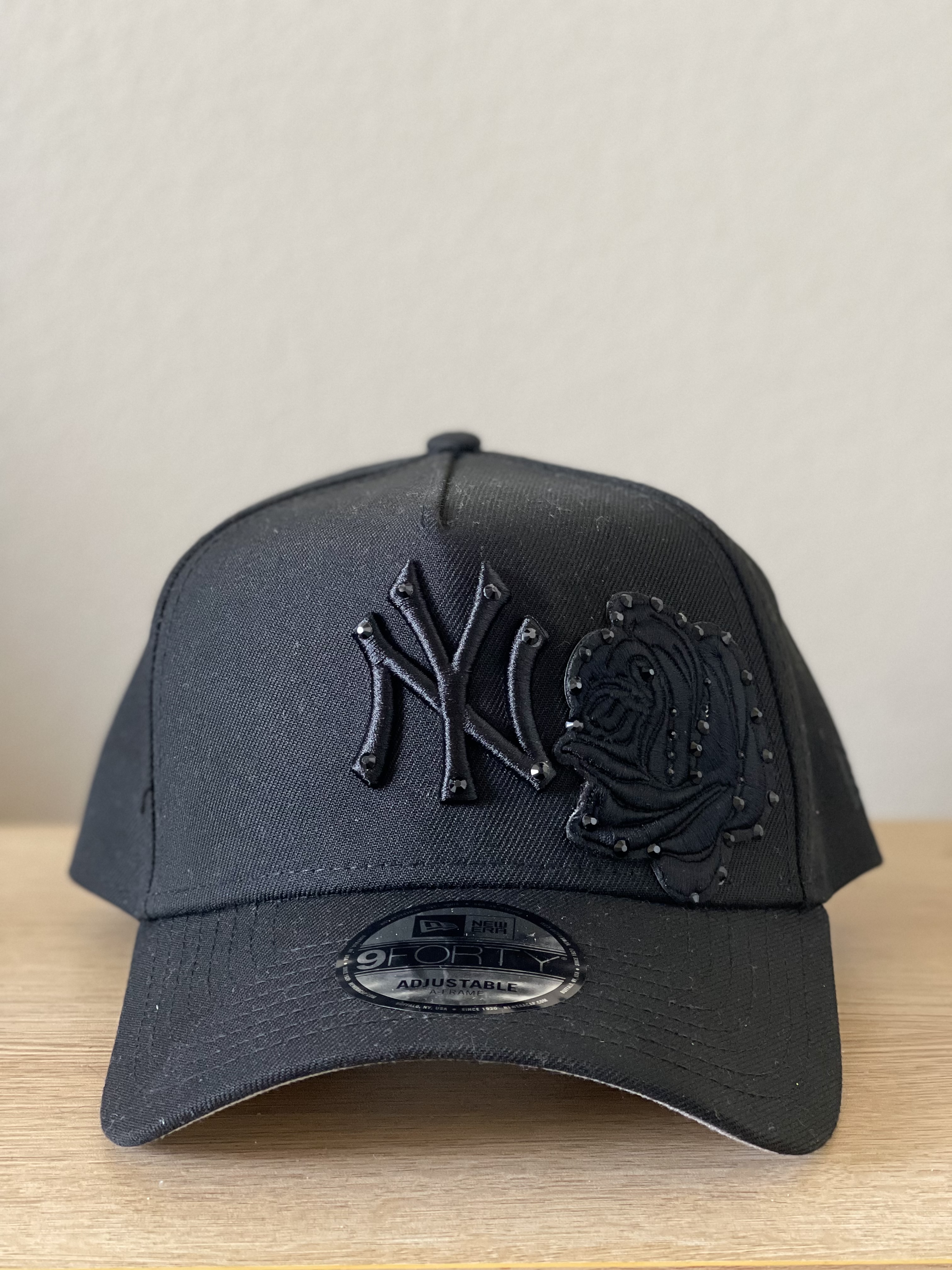 Black Yankees snapback with tonal black rose applique, front view.